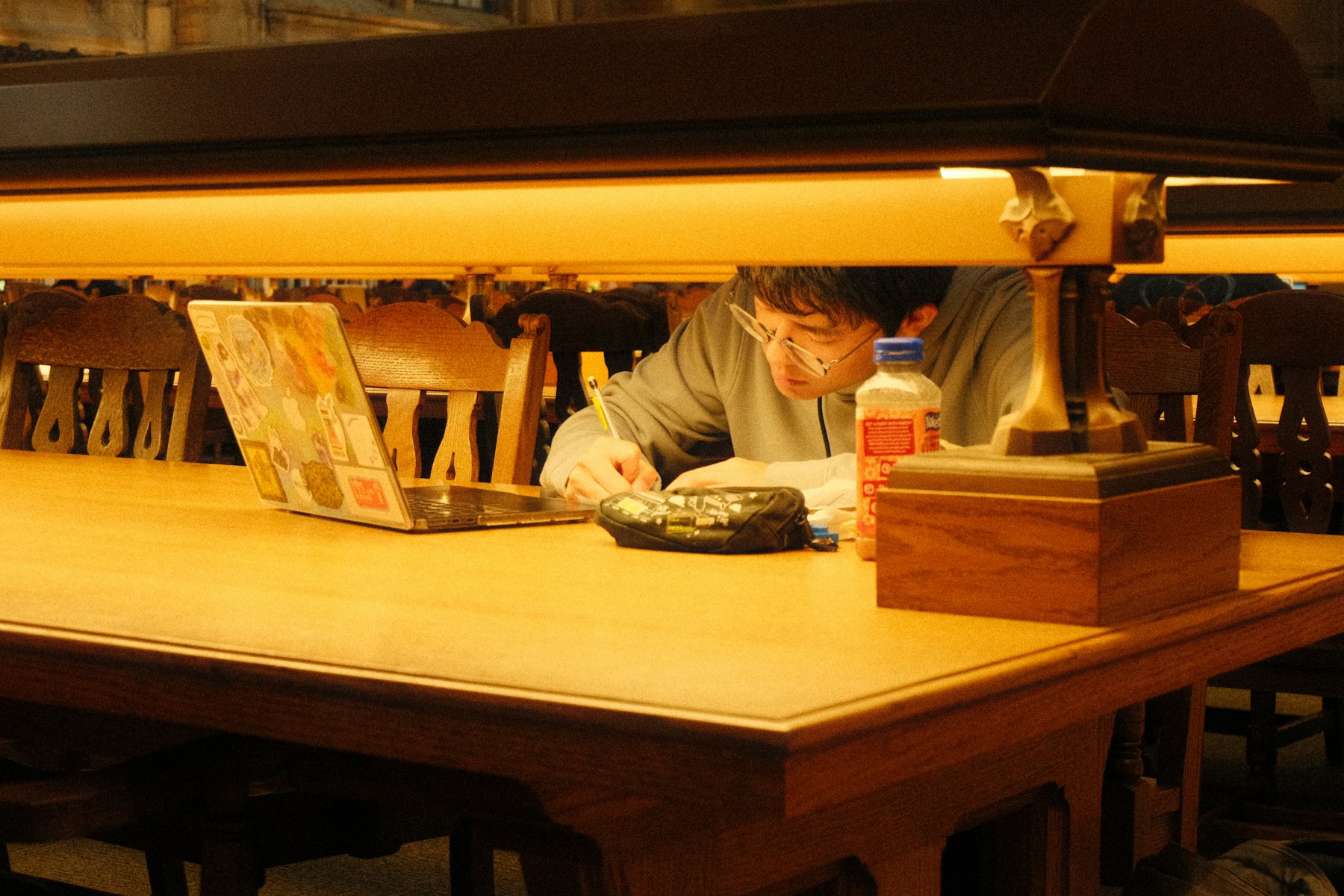 A focused student studying in a library
